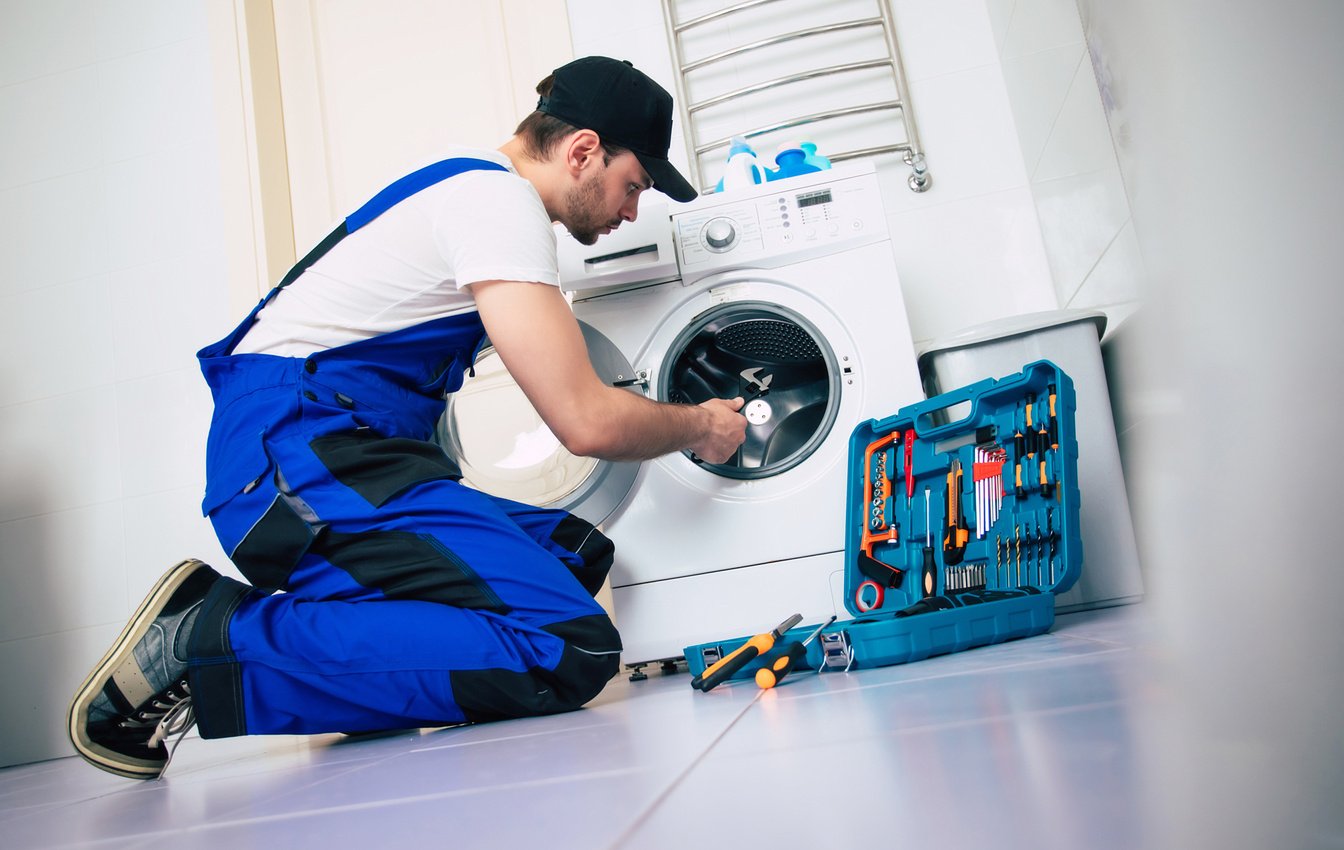 Mechanic Repairing Washing Machine